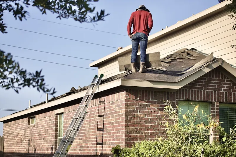 Professional roofer working on a residential roof in South Meadows Farms